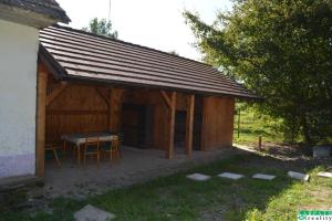 a wooden shed with a table and chairs in it at Chalúpka na Podkylave in Podkylava +2 photos