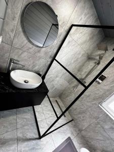 a bathroom with a sink and a mirror at Шале WeLKoMe in Verkhovyna +58 photos