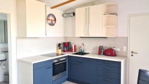 a kitchen with blue cabinets and a counter top at PONTUS Ferienwohnung FeWo2 in Zislow