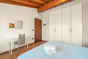 a bedroom with a bed and a desk at Villa Luna Appartements und Spa in Calmasino +36 photos