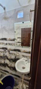 a bathroom with a sink and a mirror at Hotel Royal galaxy in Dharāsu