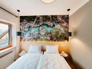 a bedroom with two beds and a painting on the wall at Hotel Oskar Zaplata in Preddvor +140 photos