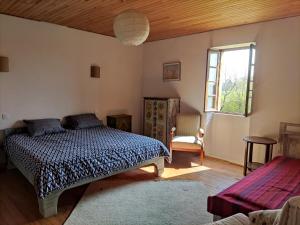 a bedroom with a bed and a window at "Hertou" in Clèdes
