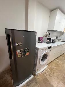a kitchen with a refrigerator and a washing machine at Brand new furnished studio Apartment near old Town in Phuket