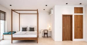 a bedroom with a bed and a desk with a chair at Eco Resort WildLand - Zanzibar in Bwejuu +1 photo