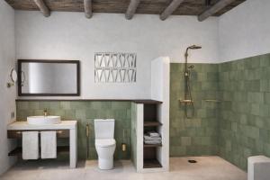 a bathroom with a toilet and a sink and a shower at Eco Resort WildLand - Zanzibar in Bwejuu