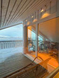 a balcony with a bench on the side of a house at Exclusive Northernlight villa at Sørtromsøya in Tromsø