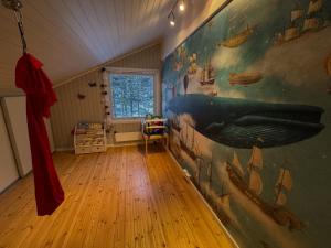 a room with a large mural on the wall at Exclusive Northernlight villa at Sørtromsøya in Tromsø