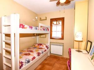a bedroom with two bunk beds and a desk at Casa Socias in Comarruga +19 photos