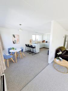 a living room with a couch and a table at 3 bedroom hidden gem in Gore +2 photos