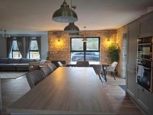 a living room with a large wooden table and chairs at Teach Annie in Annagry