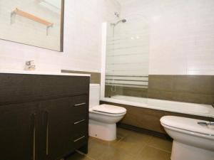 a bathroom with a toilet and a sink and a bath tub at Casa Rosalia in Roda de Bará +13 photos