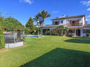 a large house with a yard with a pool at Villa Maite in Roda de Bará