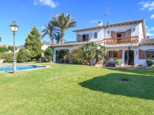 a large house with a yard with a swimming pool at Villa Maite in Roda de Bará