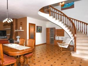 a living room with a dining table and a staircase at Villa Maite in Roda de Bará