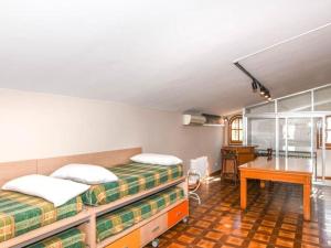 a bedroom with two beds and a desk and a table at Villa Maite in Roda de Bará +31 photos