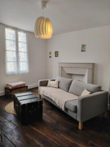 a living room with a couch and a fireplace at Nouveau - Maison de charme - Centre de Bourdeilles in Brantome en Perigord