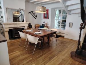 a dining room with a table and chairs and a fireplace at Nouveau - Maison de charme - Centre de Bourdeilles in Brantome en Perigord