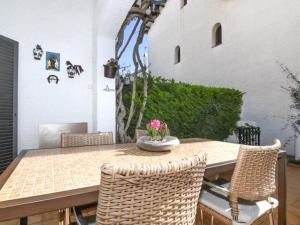 a table and chairs with a vase of flowers on it at Enric Borras in Roda de Bará