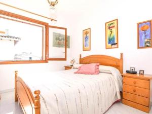 a bedroom with a bed and a dresser and a window at Enric Borras in Roda de Bará