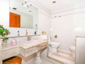 a bathroom with a sink and a toilet and a mirror at Enric Borras in Roda de Bará +11 photos