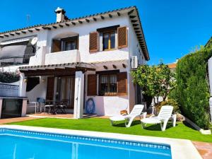 a villa with a swimming pool in front of a house at Casa Marti in Roda de Bará