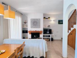 a dining room with a table and a fireplace at Casa Marti in Roda de Bará