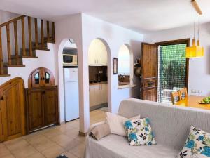 a living room with a couch and a kitchen at Casa Marti in Roda de Bará