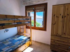 a bedroom with a bunk bed and a window at Casa Marti in Roda de Bará +19 photos