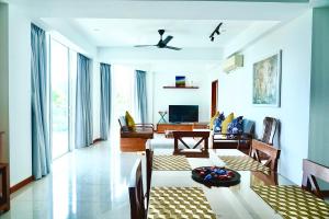 a living room with a table and a dining room at Dreamwave Escape Nilaveli in Nilaveli