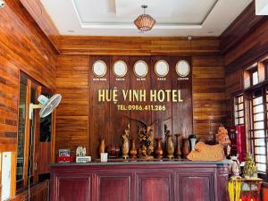 a room with a wooden wall with clocks on it at Hue Vinh Hotel in Thương Xà (2)