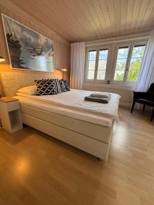a bedroom with a large bed in a room with windows at Lake Park Apartment in Interlaken