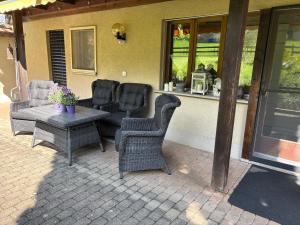 a group of chairs and a table on a patio at Lake Park Apartment in Interlaken