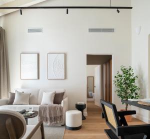 a living room with a couch and a table at Magno Collection Palacio de Becas in Seville