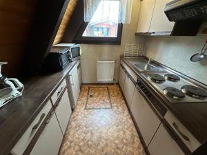 a small kitchen with a stove and a sink at Ferienhaus Hasenglück in Waldbrunn +13 photos