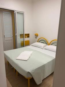 a bedroom with a large bed with a mirror at Hotel Vienna in Senigallia