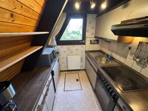 a small kitchen with a sink and a window at Ferienhaus Eichhörnchennest in Waldbrunn