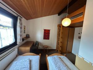 a small room with two beds and a window at Ferienhaus Morgentau in Waldbrunn