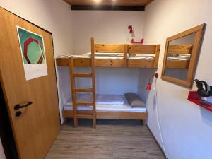 a room with two bunk beds and a door at Ferienhaus Mooswinkel in Waldbrunn +13 photos