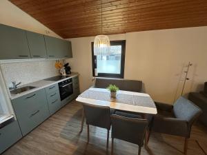 a kitchen with a table and chairs in a kitchen at Ferienhaus Mooswinkel in Waldbrunn