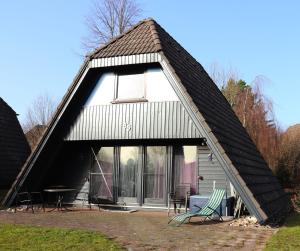 a house with a gambrel roof with a large window at Ferienhaus Schneekristall in Waldbrunn