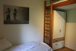 a bedroom with a bunk bed and a bunk ladder at Ferienhaus Krappennest in Waldbrunn +14 photos