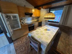 a small kitchen with a table and a sink and a table and chairs at Ferienhaus Abendstille in Waldbrunn