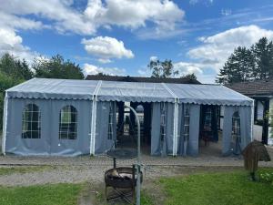 a white tent in front of a house at Ferienhaus Winterruhe in Waldbrunn +10 photos