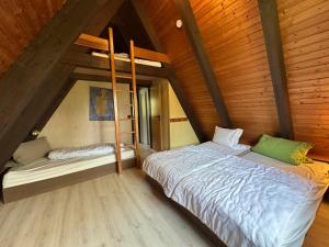 a bedroom with two beds in a wooden room at Ferienhaus Abendzauber in Waldbrunn +13 photos