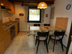 a kitchen with a table and chairs in a kitchen at Ferienhaus Urlaubsfreude in Waldbrunn