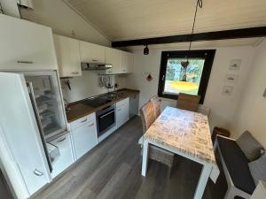 a small kitchen with a table and a window at Ferienhaus Gartenglück in Waldbrunn