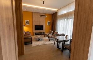 a living room with a table and a dining room at Hotel Dilijan Resort in Dilijan