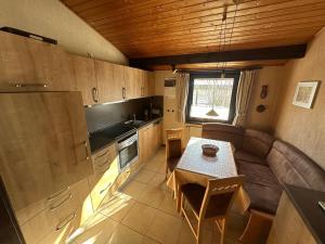a small kitchen with a table and a couch at Ferienhaus Romantiknest in Waldbrunn