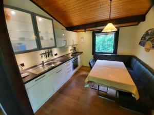 a kitchen with a wooden table and a sink at Ferienhaus Romantikruhe in Waldbrunn +11 photos